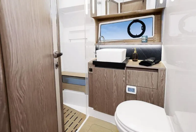 Slide: The Image of Modern bathroom in 2025 Sealine F430 yacht with wood accents and sleek fixtures. - 32