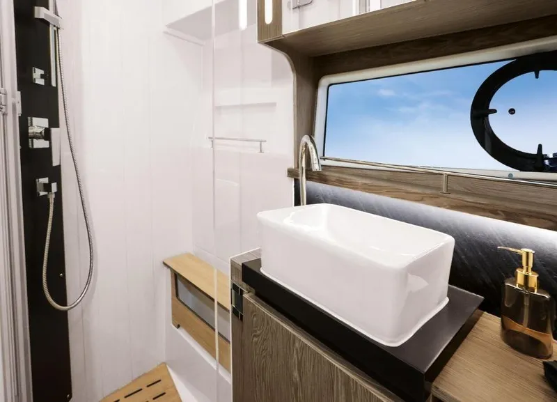 Slide: The Image of Luxurious bathroom interior of 2025 Sealine F430 yacht with modern sink and window view. - 33