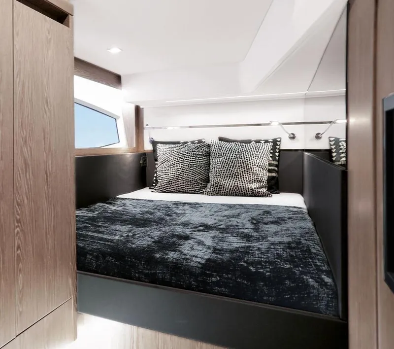 Slide: The Image of Luxurious cabin interior of 2025 Sealine F430 yacht with modern bedding and wood accents. - 40