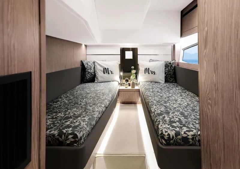 Slide: The Image of Luxurious 2025 Sealine F430 cabin with twin beds, elegant decor, and personalized pillows. - 41