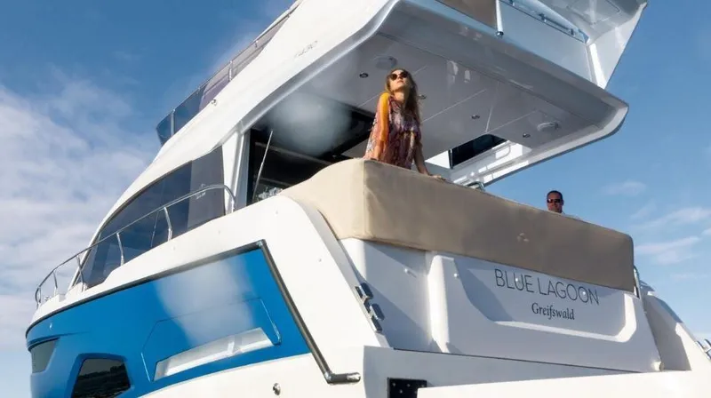 Slide: The Image of 2025 Sealine F430 yacht "Blue Lagoon" with people enjoying the deck. - 7