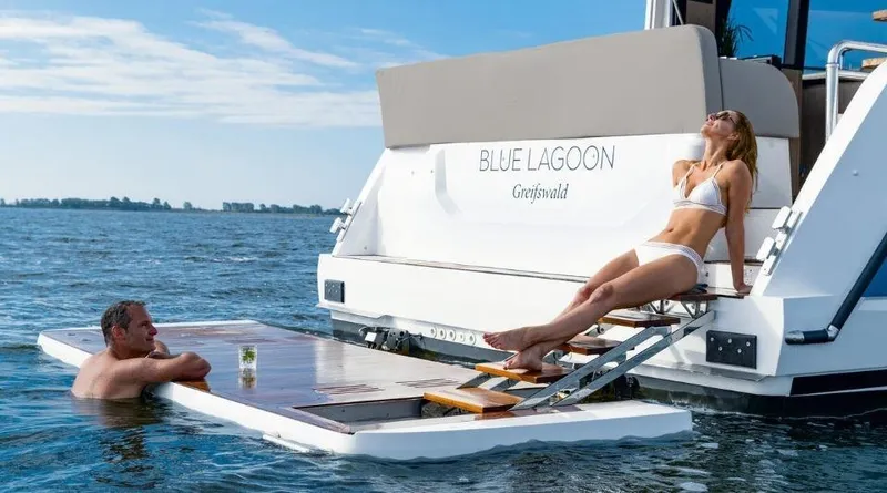 Slide: The Image of Sealine F430 yacht, 2025 model, with people relaxing on a swim platform in the ocean. - 9