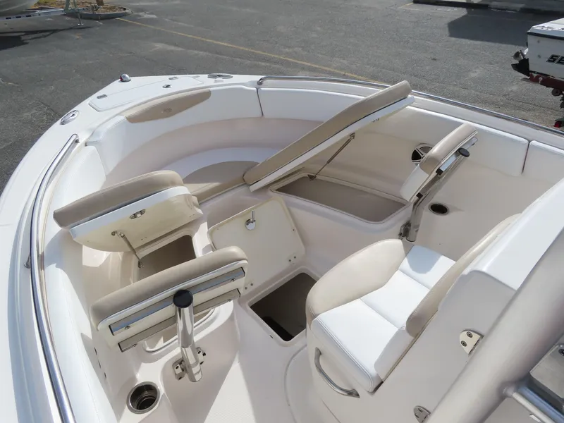 Slide: The Image of 2018 Robalo R222 Center Console boat interior with white seating and storage compartments. - 10