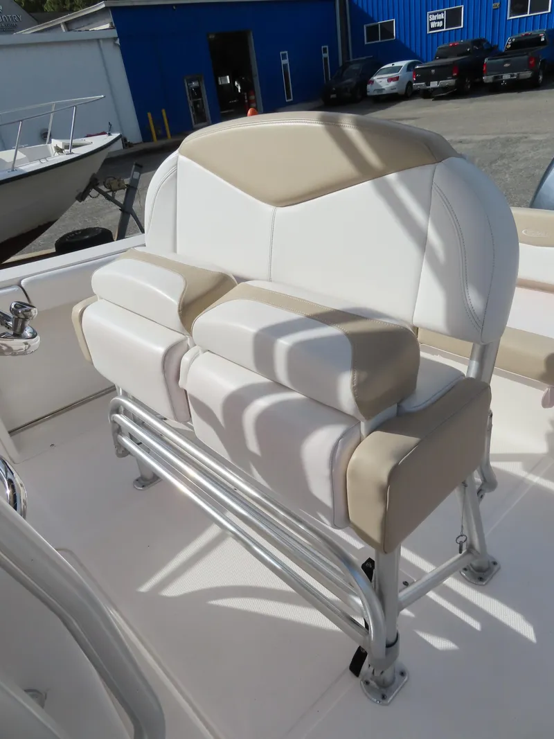 Slide: The Image of 2018 Robalo R222 Center Console boat seat with beige and white upholstery. - 15