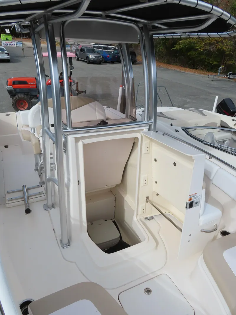 Slide: The Image of 2018 Robalo R222 Center Console boat interior with open storage compartment. - 17