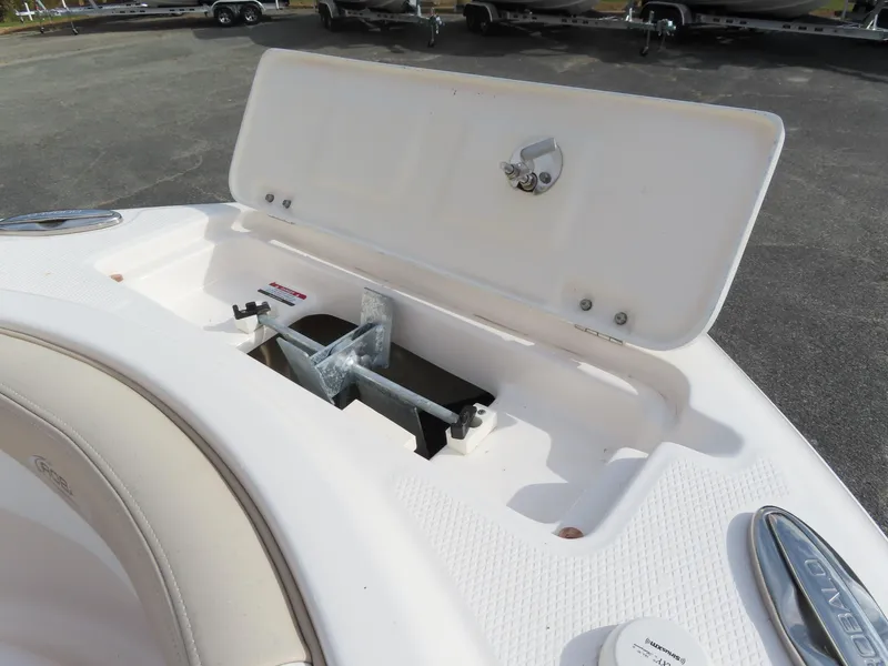 Slide: The Image of 2018 Robalo R222 Center Console boat anchor storage compartment open. - 18