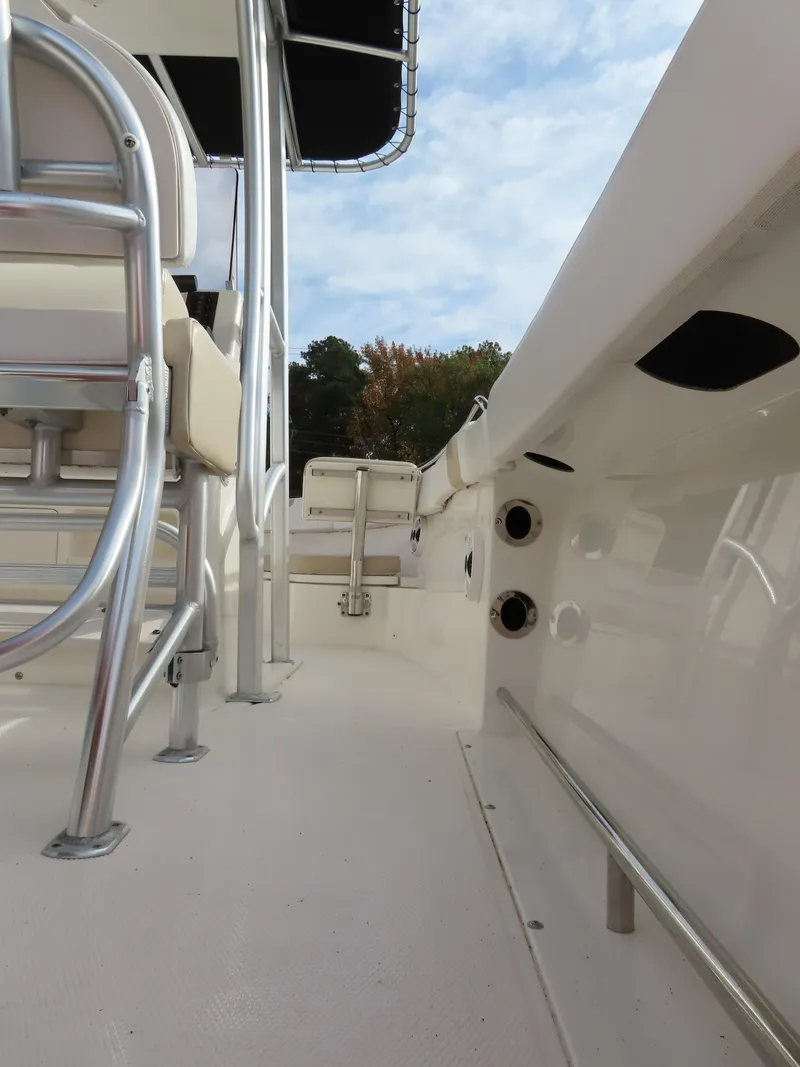 Slide: The Image of 2018 Robalo R222 Center Console boat interior with seating and railing. - 19