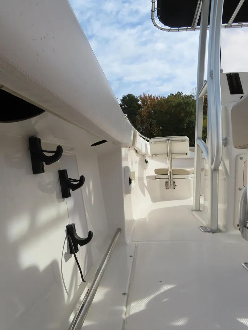 Slide: The Image of 2018 Robalo R222 Center Console boat interior with rod holders and seating. - 20