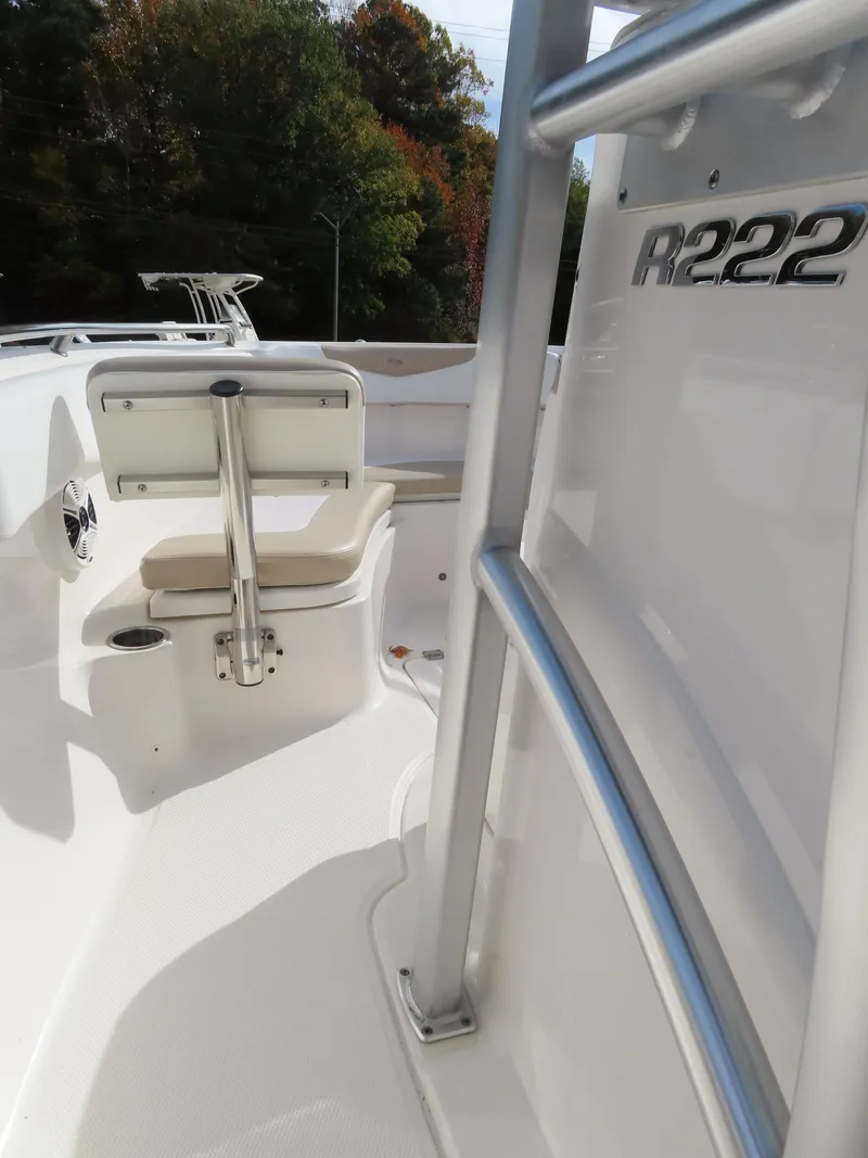 Slide: The Image of 2018 Robalo R222 Center Console boat interior with seating and railing. - 21