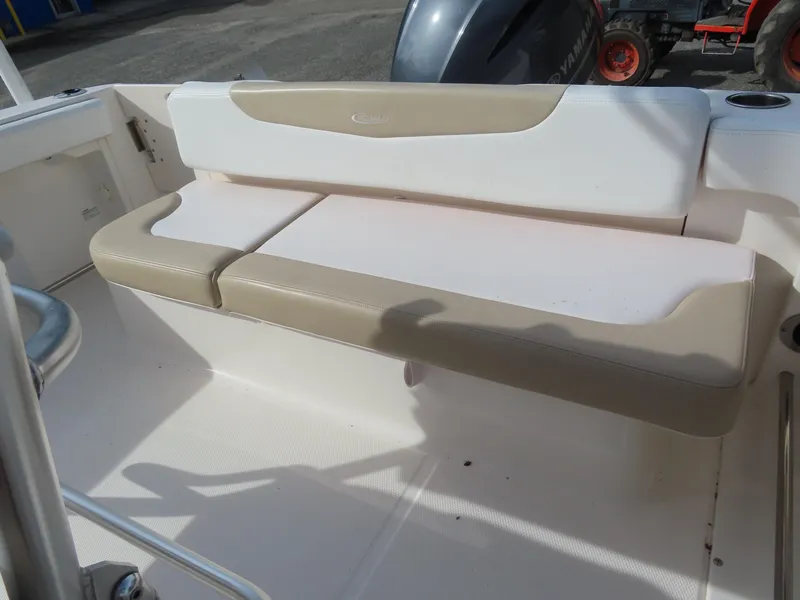 Slide: The Image of 2018 Robalo R222 Center Console boat seating area with beige and white cushions. - 22