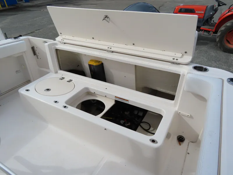 Slide: The Image of 2018 Robalo R222 Center Console boat storage compartments and seating area. - 23