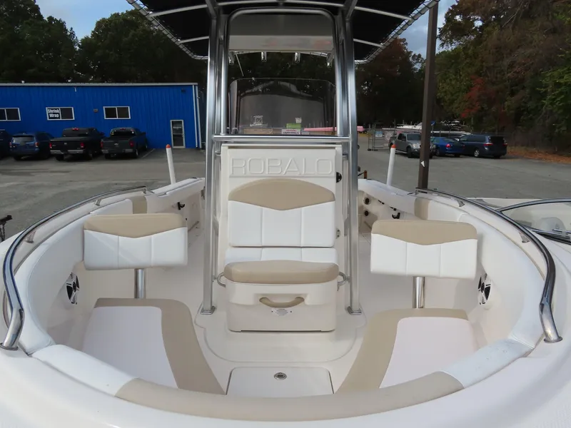 Slide: The Image of 2018 Robalo R222 Center Console boat with seating and storage, parked outdoors. - 5