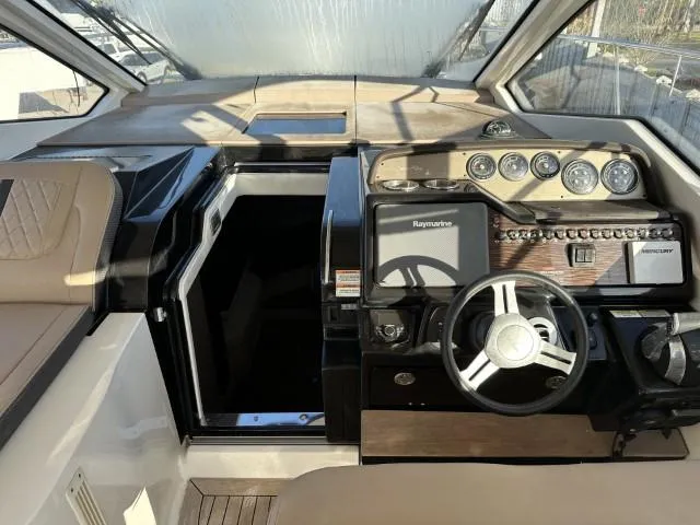 Slide: The Image of Interior helm of 2017 Sea Ray Sundancer 350 Coupe with modern controls and steering wheel. - 1