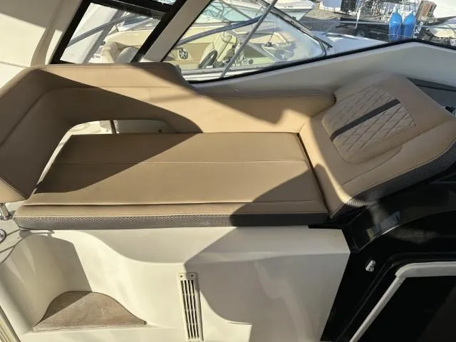 Slide: The Image of 2017 Sea Ray Sundancer 350 Coupe interior with beige seating and modern design. - 10