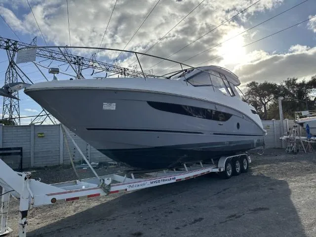 Slide: The Image of 2017 Sea Ray Sundancer 350 Coupe on trailer under cloudy sky. - 13