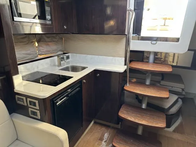 Slide: The Image of Interior of 2017 Sea Ray Sundancer 350 Coupe with modern kitchen and wooden stairs. - 16
