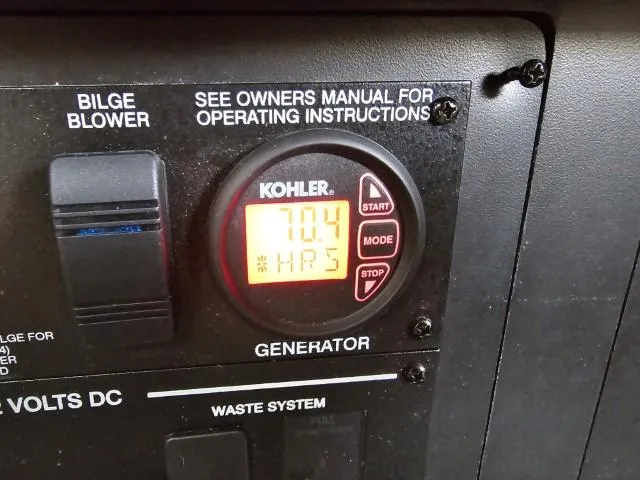 Slide: The Image of Kohler generator control panel on 2017 Sea Ray Sundancer 350 Coupe, showing 704 hours. - 26