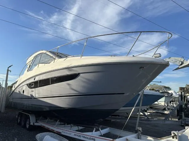 Slide: The Image of 2017 Sea Ray Sundancer 350 Coupe on trailer, docked under clear sky. - 27