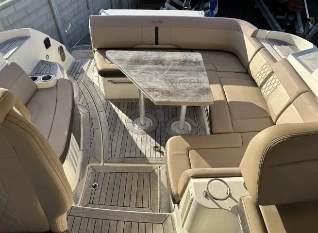 Slide: The Image of 2017 Sea Ray Sundancer 350 Coupe interior with beige seating and wooden table. - 7