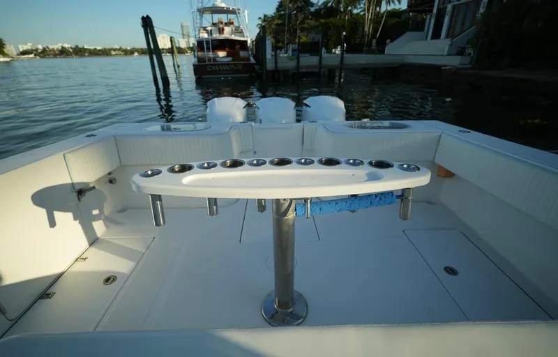 Slide: The Image of 2016 SeaHunter 41 Tournament boat deck with rod holders, docked by the water. - 13