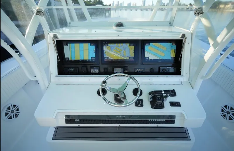 Slide: The Image of 2016 SeaHunter 41 Tournament boat dashboard with navigation screens and steering wheel. - 17