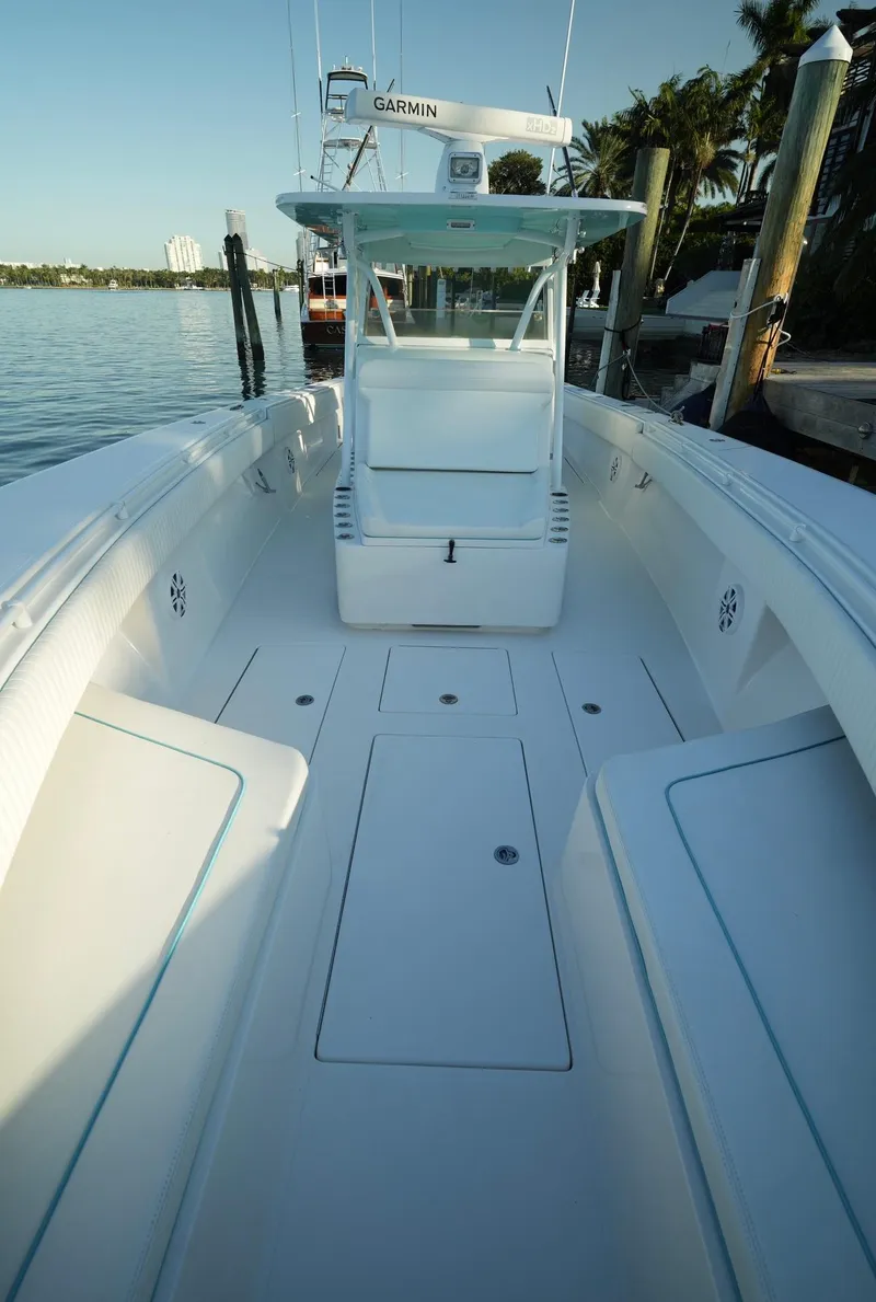 Slide: The Image of 2016 SeaHunter 41 Tournament boat docked, spacious deck, sleek design. - 19