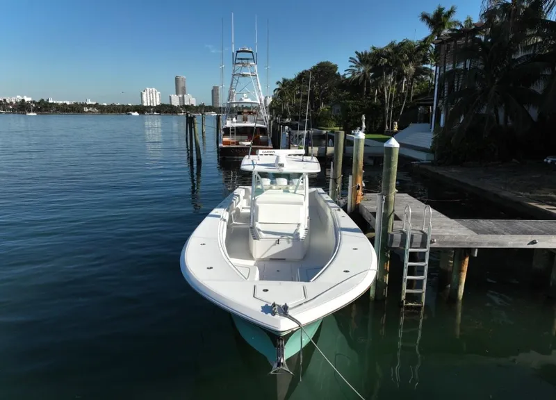 Slide: The Image of 2016 SeaHunter 41 Tournament boat docked by a scenic waterfront. - 3