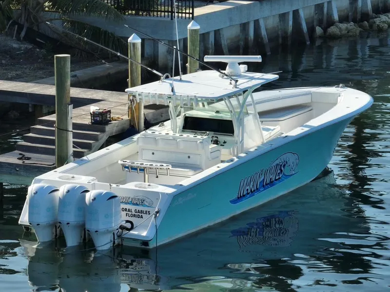 Slide: The Image of 2016 SeaHunter 41 Tournament boat docked, featuring triple outboard engines. - 4
