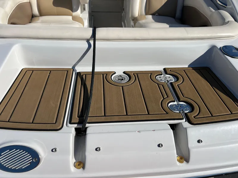 Slide: The Image of 2013 Crownline Q4 boat deck with wood finish and seating area. - 17