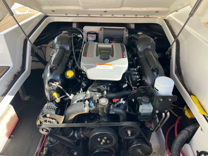 Slide: The Image of 2013 Crownline Q4 boat engine compartment with detailed view of engine components. - 18