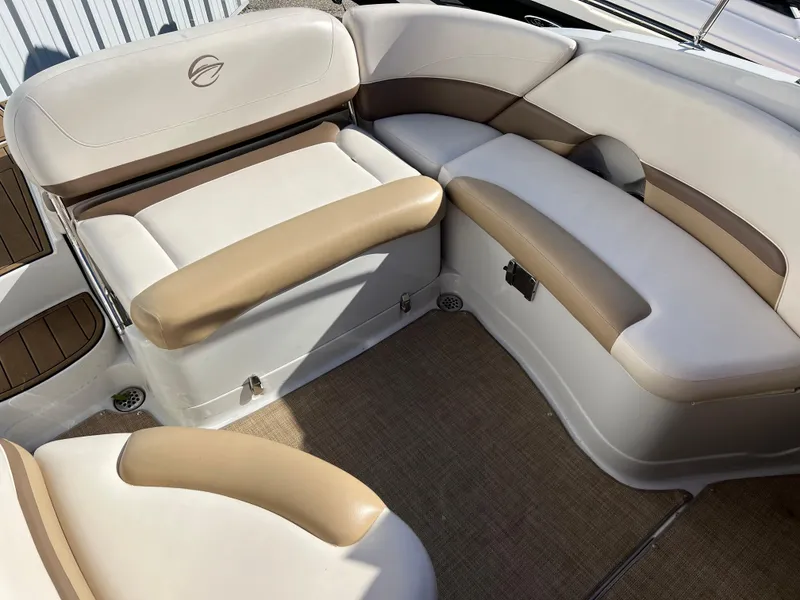 Slide: The Image of 2013 Crownline Q4 boat interior with beige and white seating. - 8