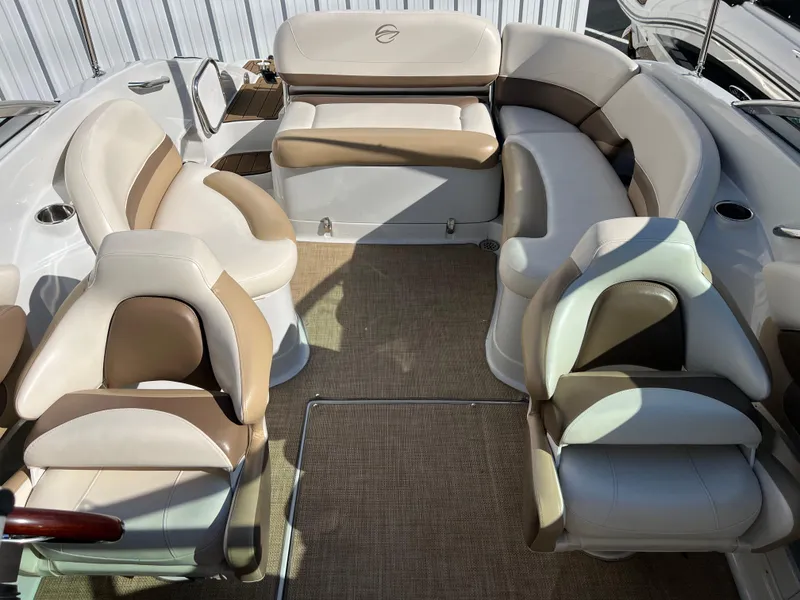 Slide: The Image of 2013 Crownline Q4 boat interior with beige and brown seating arrangement. - 9