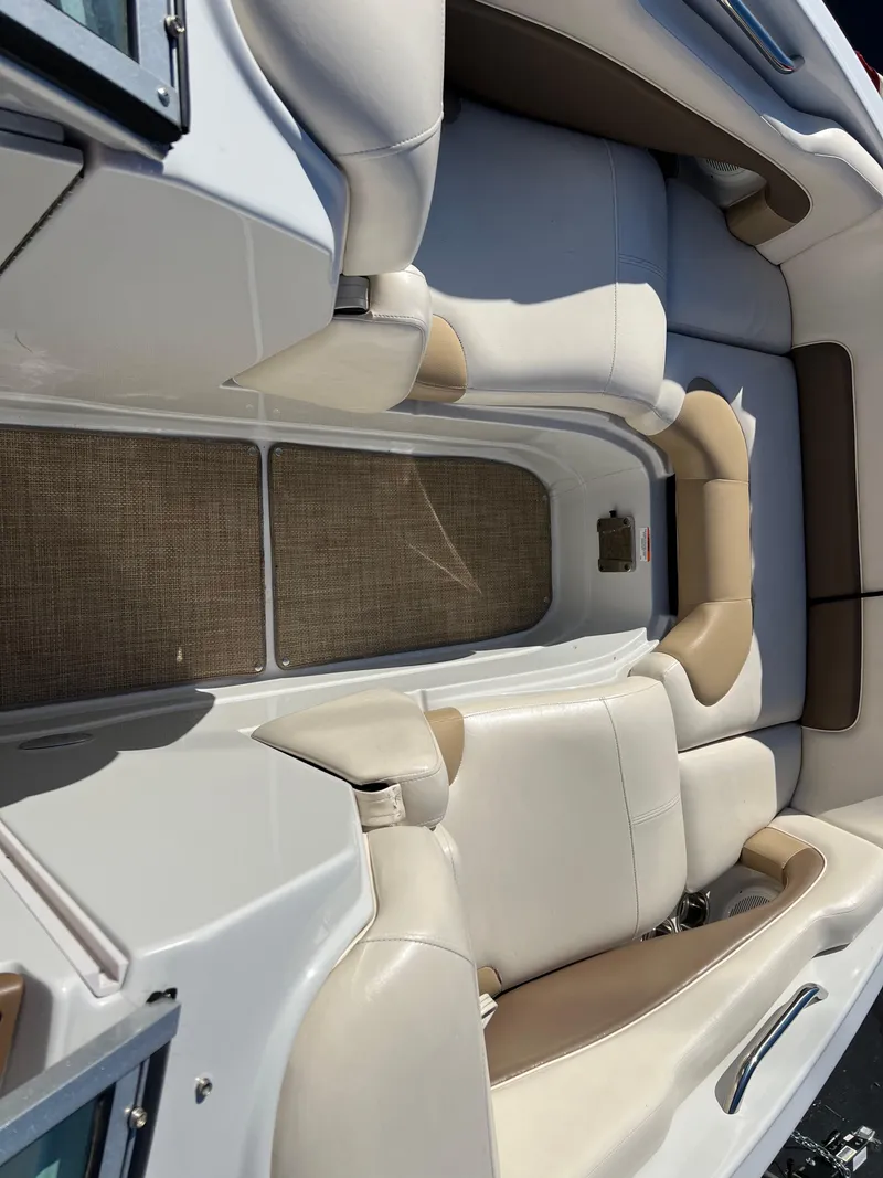 Slide: The Image of 2013 Crownline Q4 boat interior with beige and white seating. - 10
