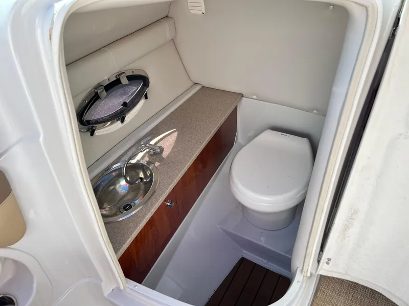 Slide: The Image of 2013 Crownline Q4 boat interior with sink and toilet. - 12