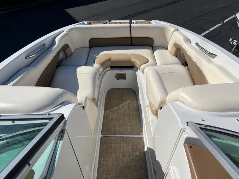 Slide: The Image of 2013 Crownline Q4 boat interior with beige and white seating. - 14
