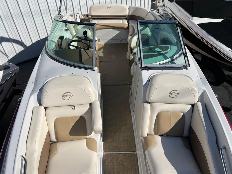 Slide: The Image of 2013 Crownline Q4 boat interior with beige seating and open cockpit. - 15