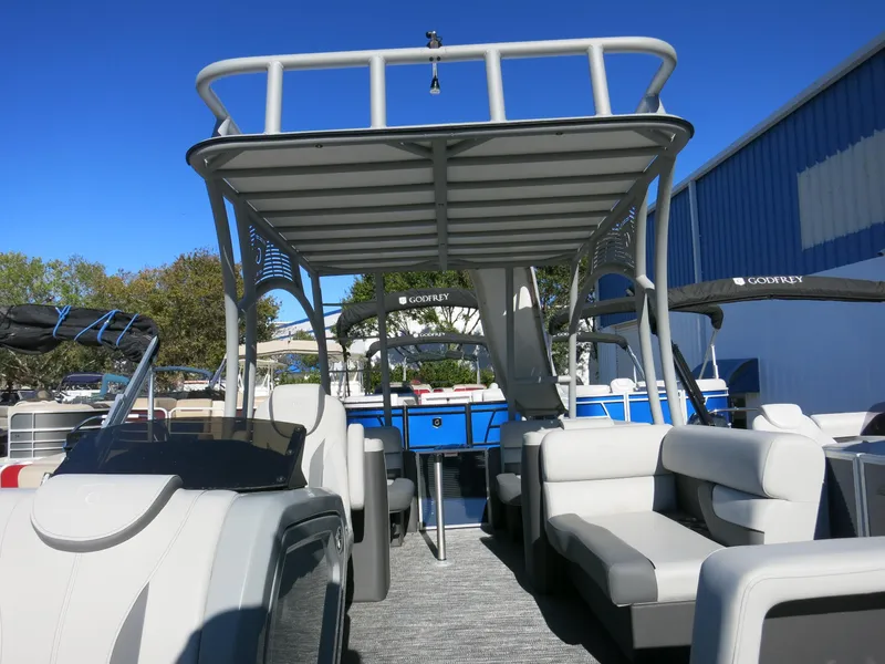 Slide: The Image of 2024 Godfrey Monaco 235SD pontoon boat with spacious seating and modern design. - 11