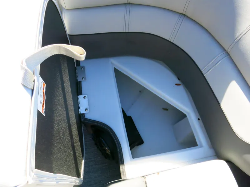 Slide: The Image of Open storage compartment in 2024 Godfrey Monaco 235SD boat with cushioned seating. - 12