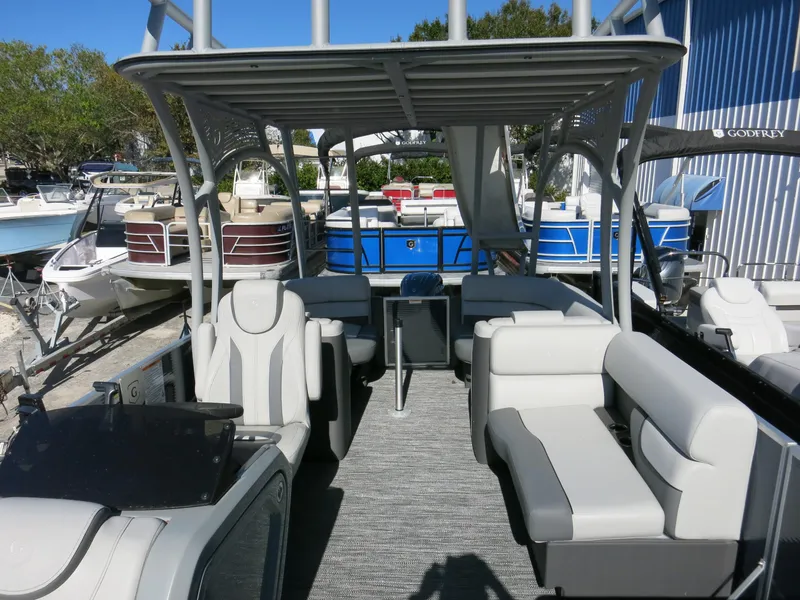 Slide: The Image of 2024 Godfrey Monaco 235SD pontoon boat with spacious seating and modern design. - 15