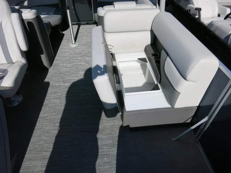 Slide: The Image of 2024 Godfrey Monaco 235SD boat interior with open storage compartment and seating. - 16