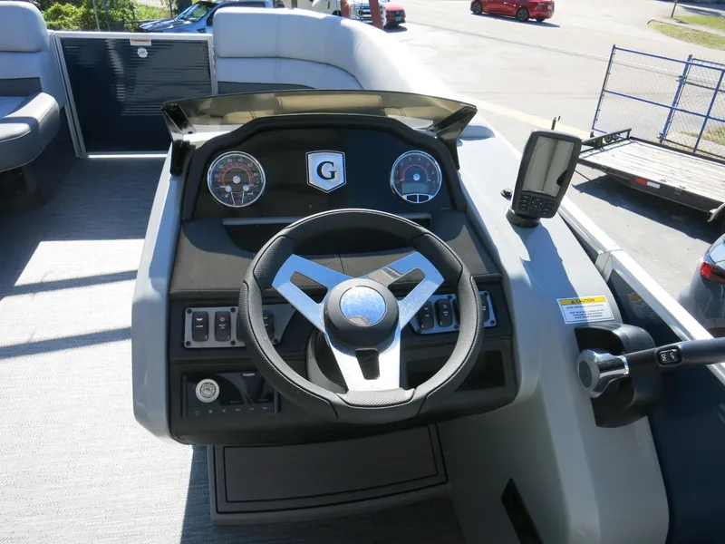 Slide: The Image of 2024 Godfrey Monaco 235SD boat dashboard with steering wheel and controls. - 19