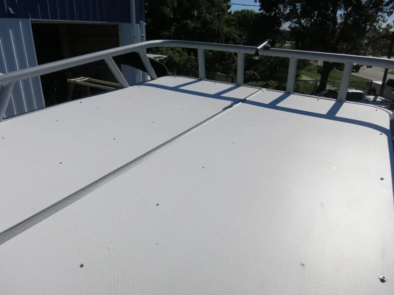 Slide: The Image of Rooftop view of 2024 Godfrey Monaco 235SD boat, featuring sleek design and sturdy railings. - 22