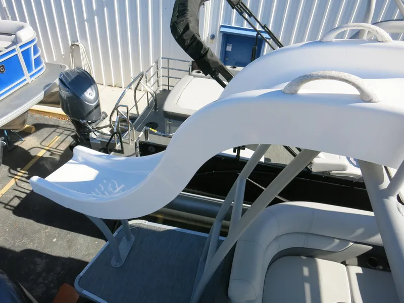 Slide: The Image of 2024 Godfrey Monaco 235SD boat with a white slide and seating area. - 23
