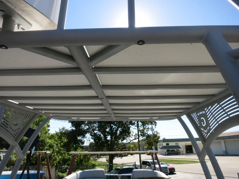 Slide: The Image of 2024 Godfrey Monaco 235SD boat canopy with sunlight and outdoor background. - 26