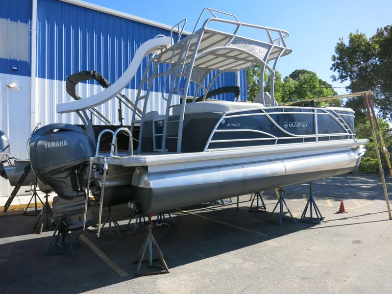 Slide: The Image of 2024 Godfrey Monaco 235SD pontoon boat with Yamaha engine on display outdoors. - 27