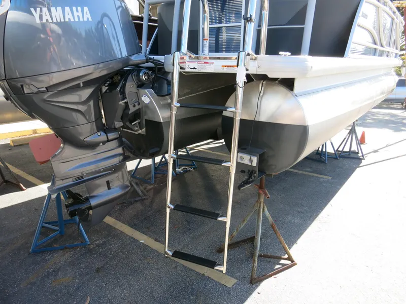 Slide: The Image of 2024 Godfrey Monaco 235SD pontoon boat with Yamaha outboard motor and boarding ladder. - 28