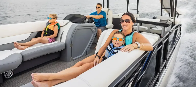 Slide: The Image of 2024 Godfrey Monaco 235SD pontoon boat with family enjoying a ride on the water. - 3