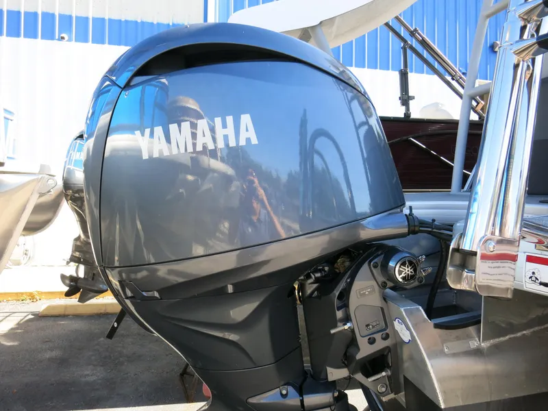 Slide: The Image of Yamaha outboard motor on 2024 Godfrey Monaco 235SD boat, docked outdoors. - 30