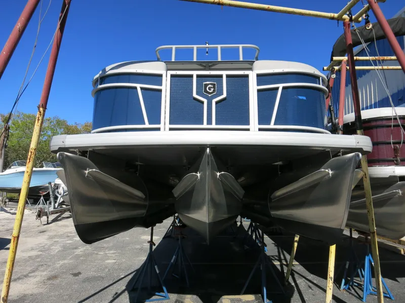 Slide: The Image of 2024 Godfrey Monaco 235SD pontoon boat on dry dock, viewed from the front. - 5