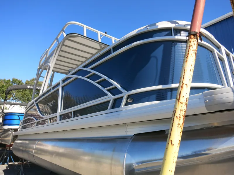 Slide: The Image of 2024 Godfrey Monaco 235SD pontoon boat with sleek design and modern features. - 6